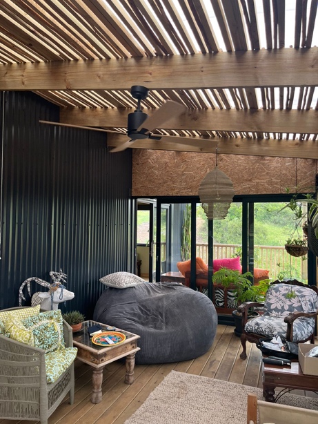 Black motor timber ceiling fan installed on a slatted covered patio