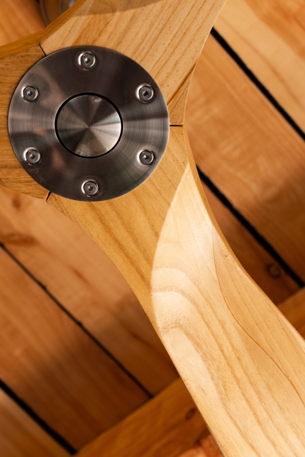 Close-up of laminated timber ceiling fan blades and stainless hub