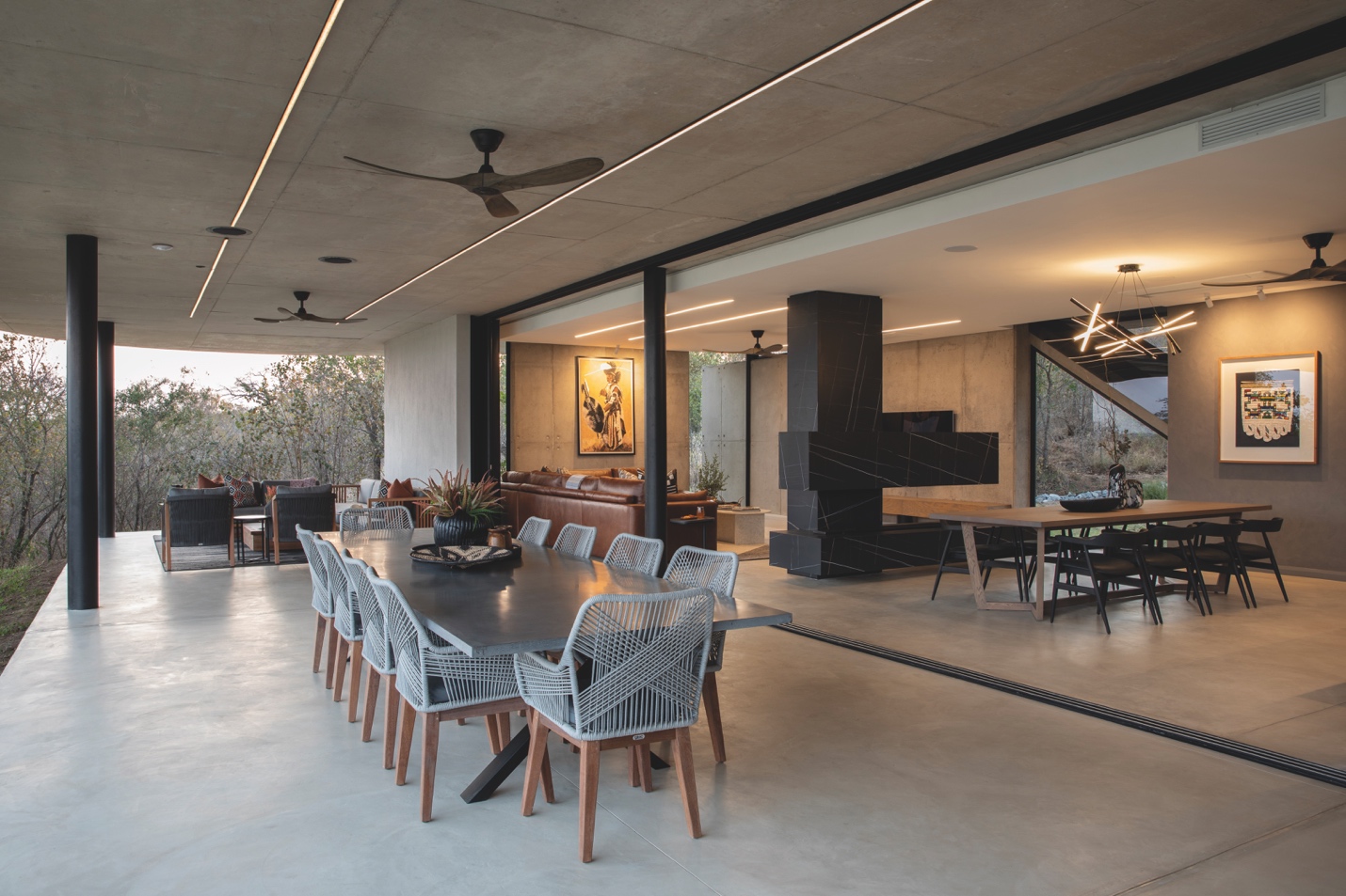 Covered indoor-outdoor dining space with timber ceiling fans